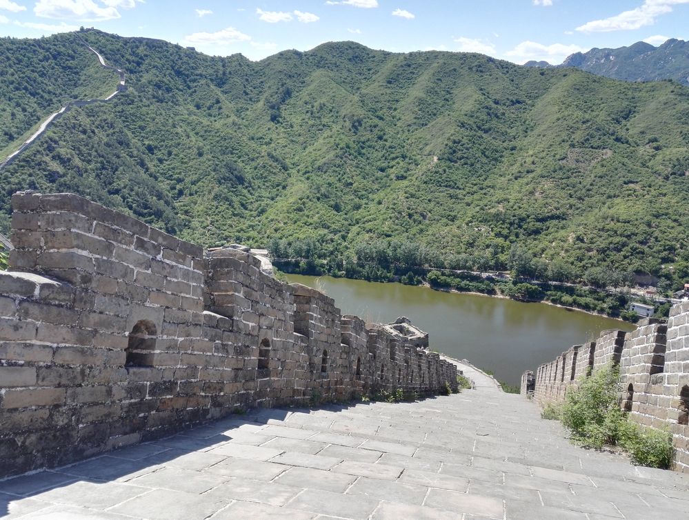 Caption: A photo of the Great Wall with a mountain view and a lake. (Local Guide @TsekoV)