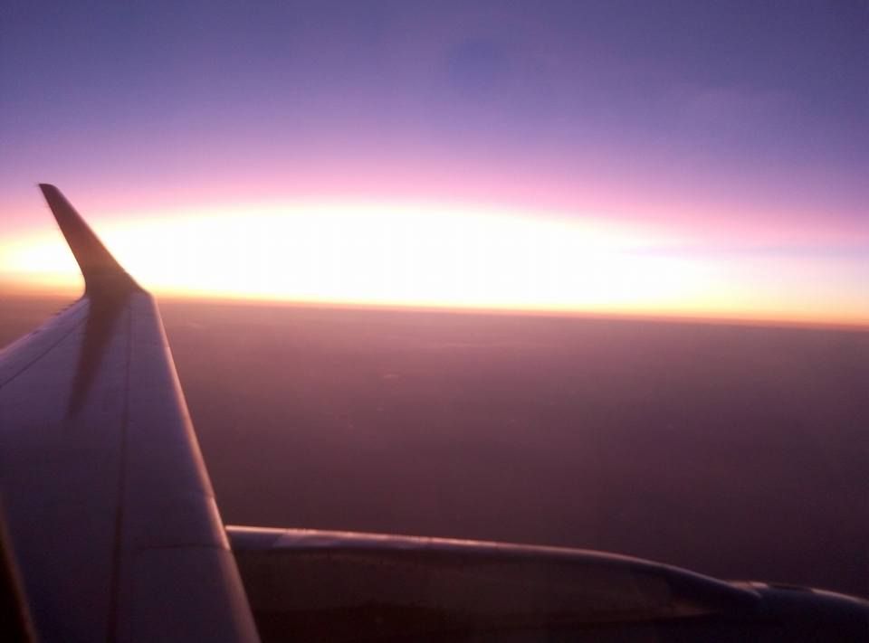 Caption: A photo captured through an airplane's window and a sunrise view on the background. (Local Guide @TsekoV)