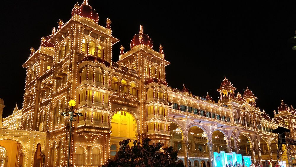Caption: A photo of Mysore Palace in Karnataka, India, lit up at night. (Local Guide Sahana S)