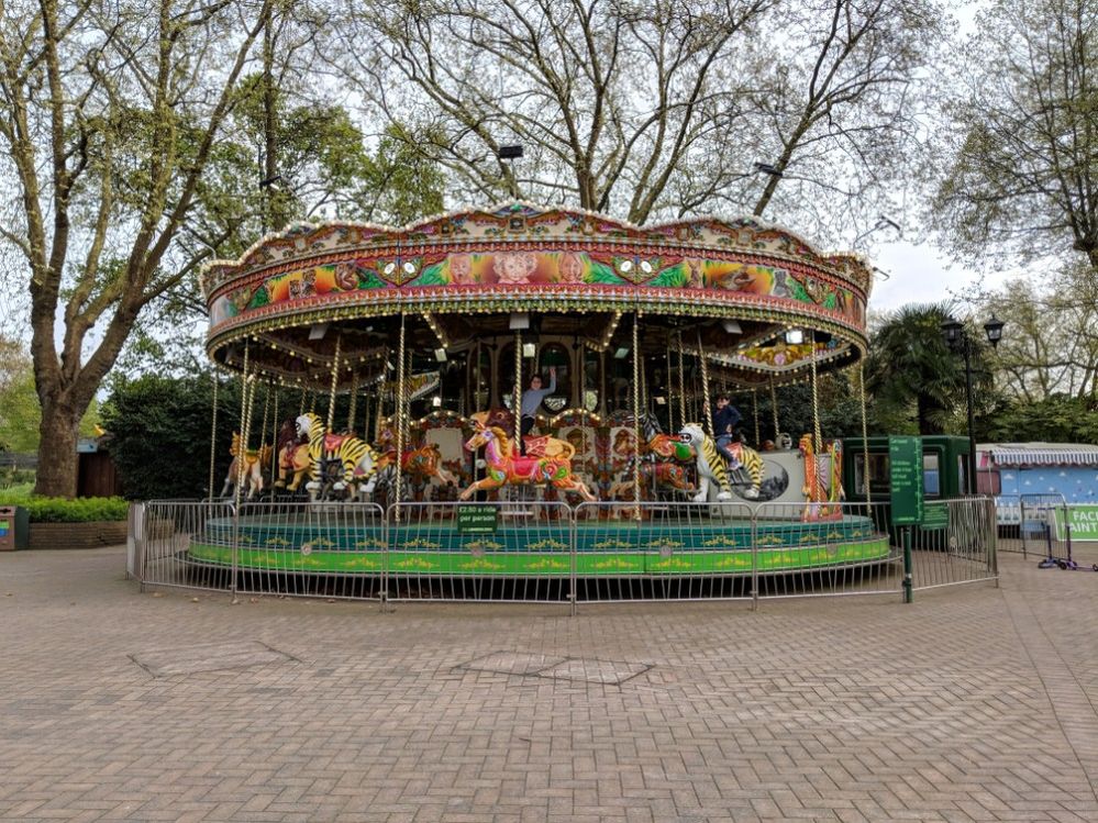 Caption: A photo of a boy and a girl enjoying a carousel ride at the London Zoo. (Local Guide Suzanne Nam)