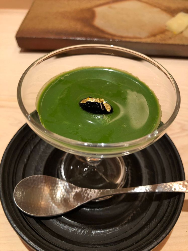 Caption: Coconut pudding with green tea sauce and edible gold