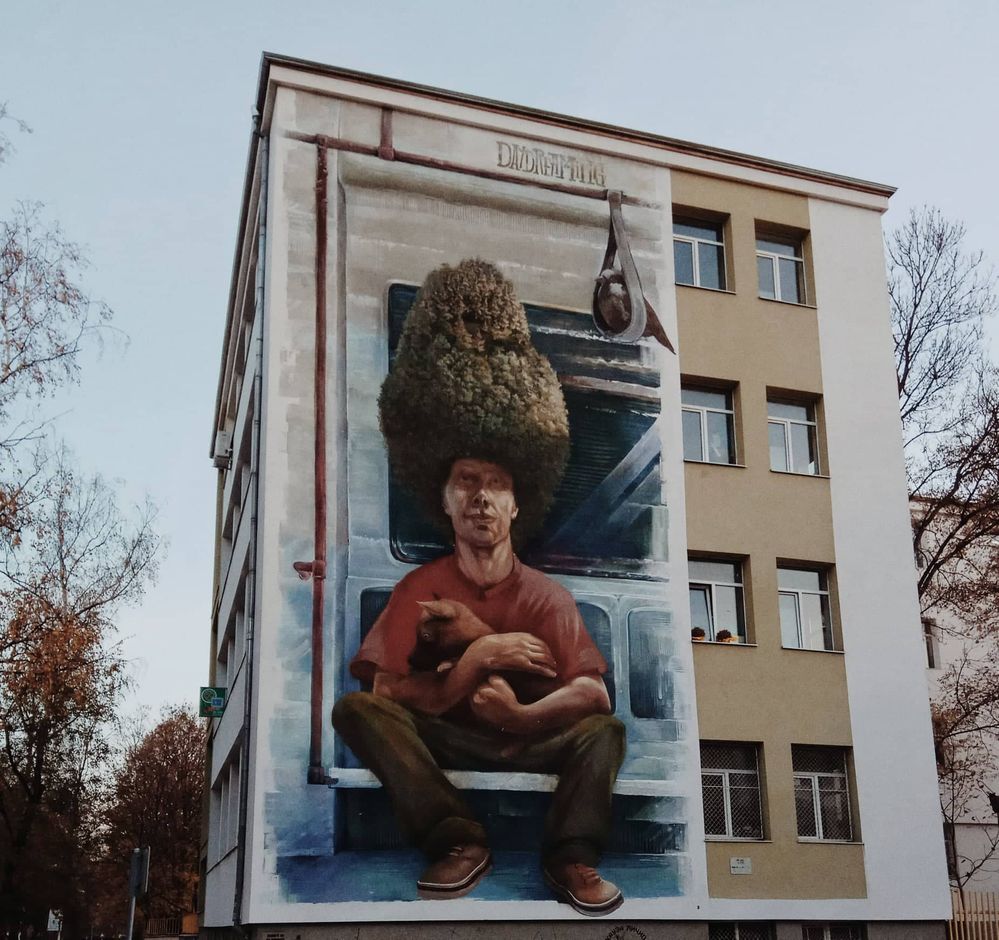 Caption: A giant piece of art in the facade of  a block of flats. On the top states Daydreaming (Local Guide VasT)
