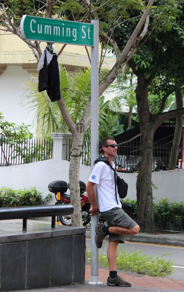 Me , hanging out on a street corner in Singapore with pants in the trees above me.. very un singapore like