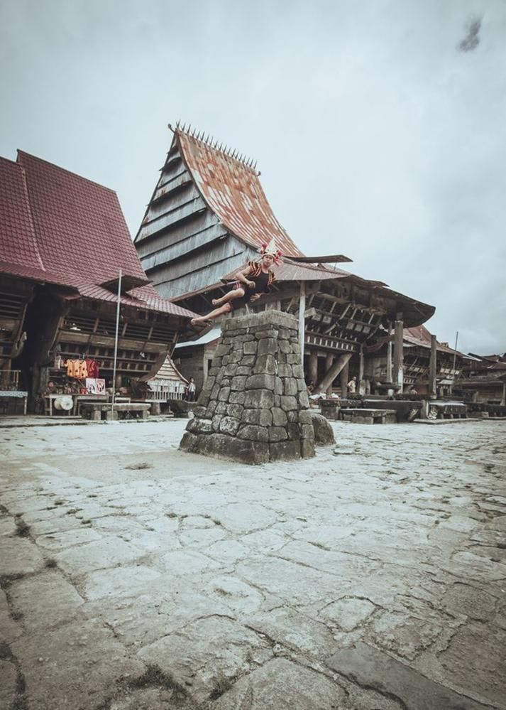 Caption: A photo of a young man participating in the tradition of stone jumping in Bawomataluo Village, Indonesia  (Local Guide FahmiAdimara)