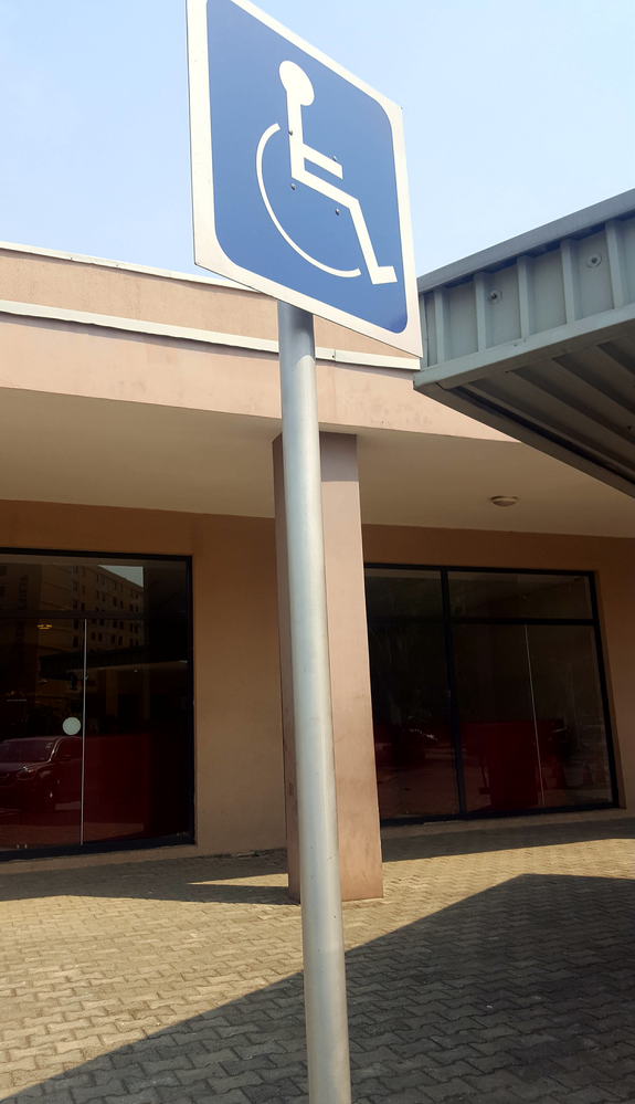 Caption: An accessible parking sign clearly postioned on the parking lot.