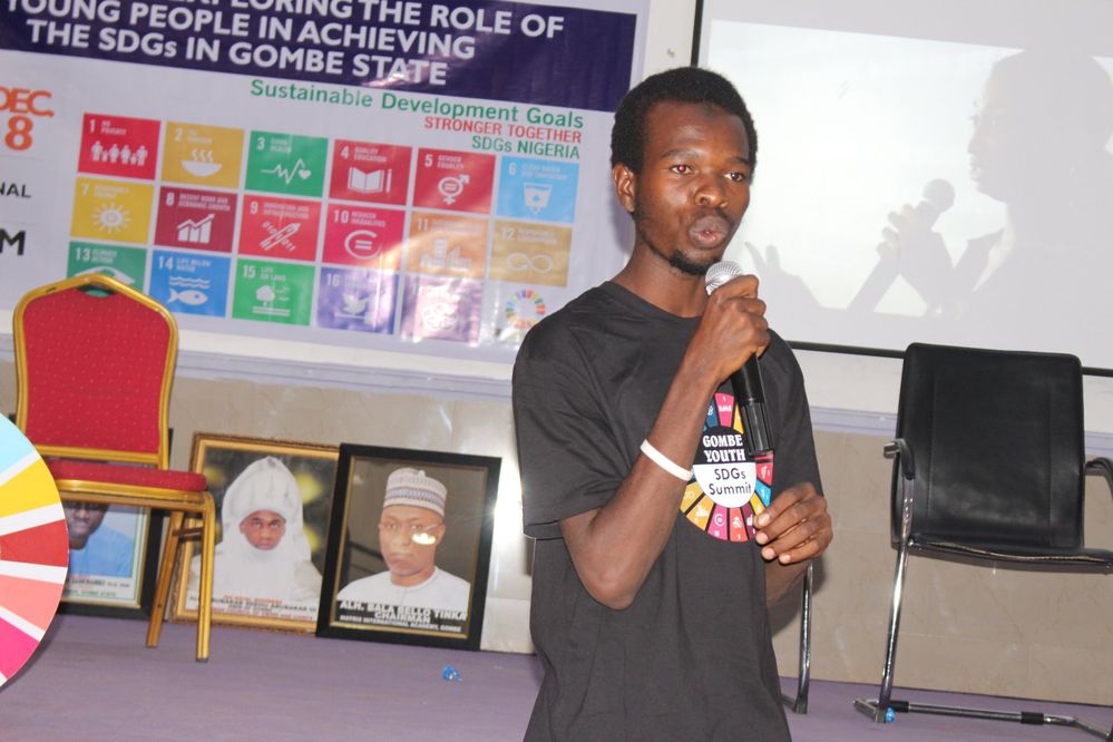 Myself (Sulaiman Abubakar Salihu) speaking at the Gombe SDGs Youth Summit with the local hero video at the background