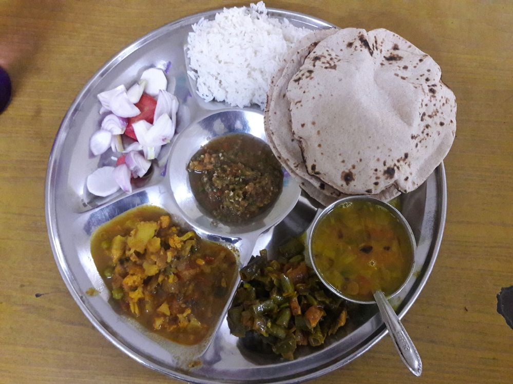 Caption: The same thali but only 2 dishes are different with some rice.