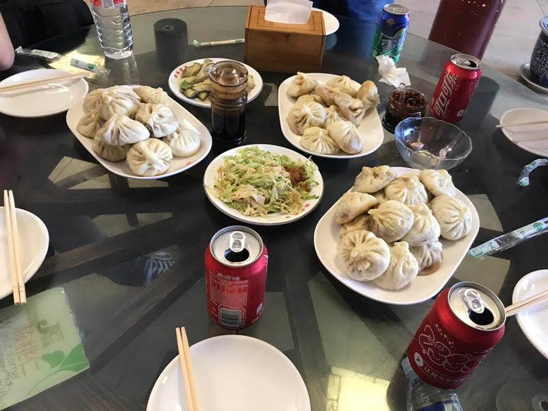 Caption: A photo of Chinese baozi, spicies, soft drinks and a salad. (Local Guide @TsekoV)
