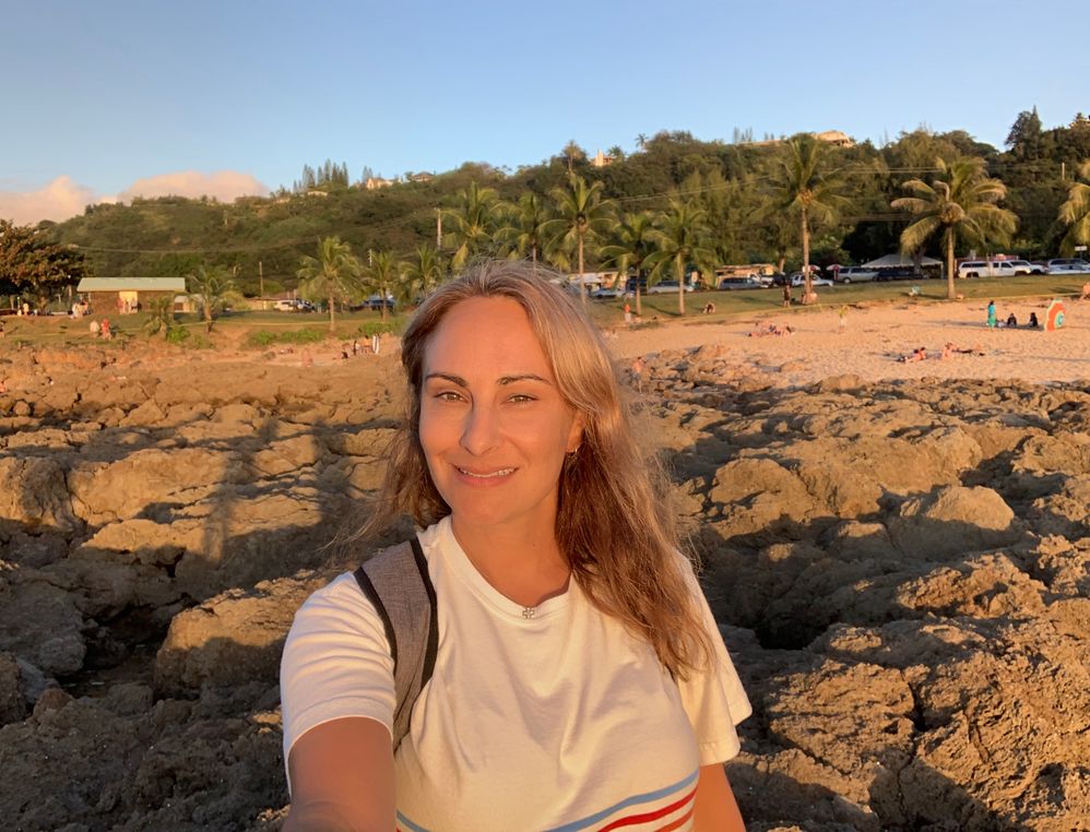 Local Guide Level 8 Penny Christie taking a selfie during a sunset at Shark's Cove, O'ahu Hawaii.