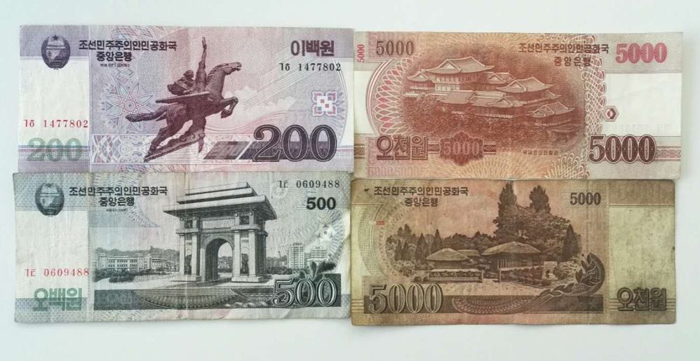 描述： 四种不同的朝鲜圆纸币的特写照片。(本地向导 @TsekoV)