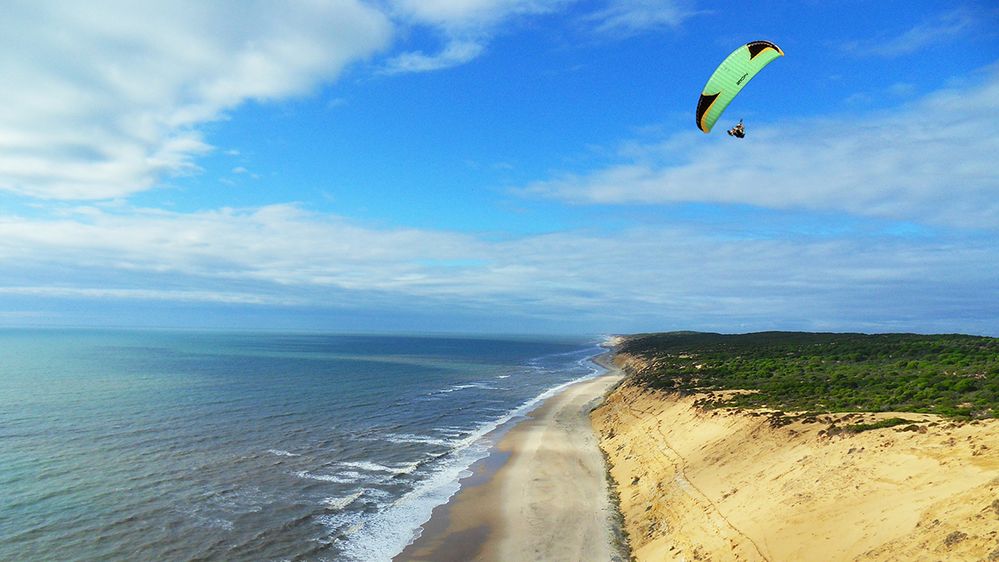 Caption: A photo of a paraglider flying over a beach in Algodonales, Spain. (Local Guide Johannes Jacobus Van Rijsbergen)