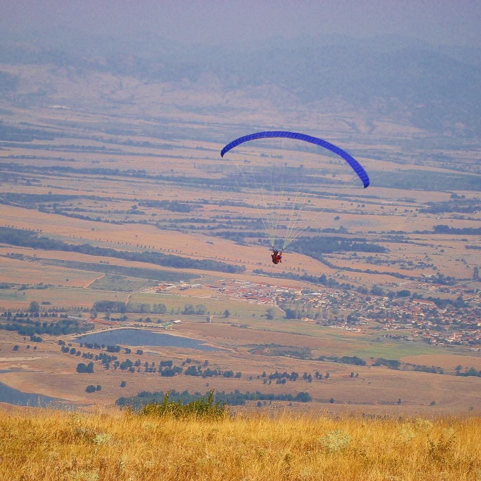 Caption: A photo of me paragliding in Bulgaria.
