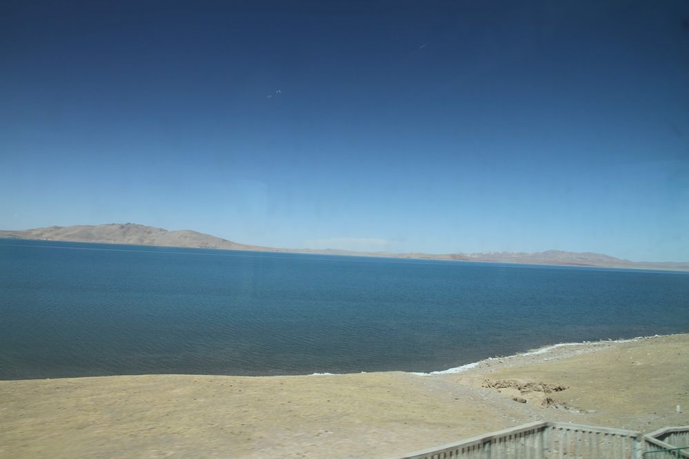 Caption: A photo taken from the train from Beijing to Lhasa of the sacred Tibetan lake Nam Co. (Local Guide @TsekoV)