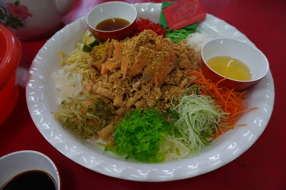 [Photo above] A traditional Yu Sheng dish, which gets mixed up by everyone to symbolize unity and prosperity
