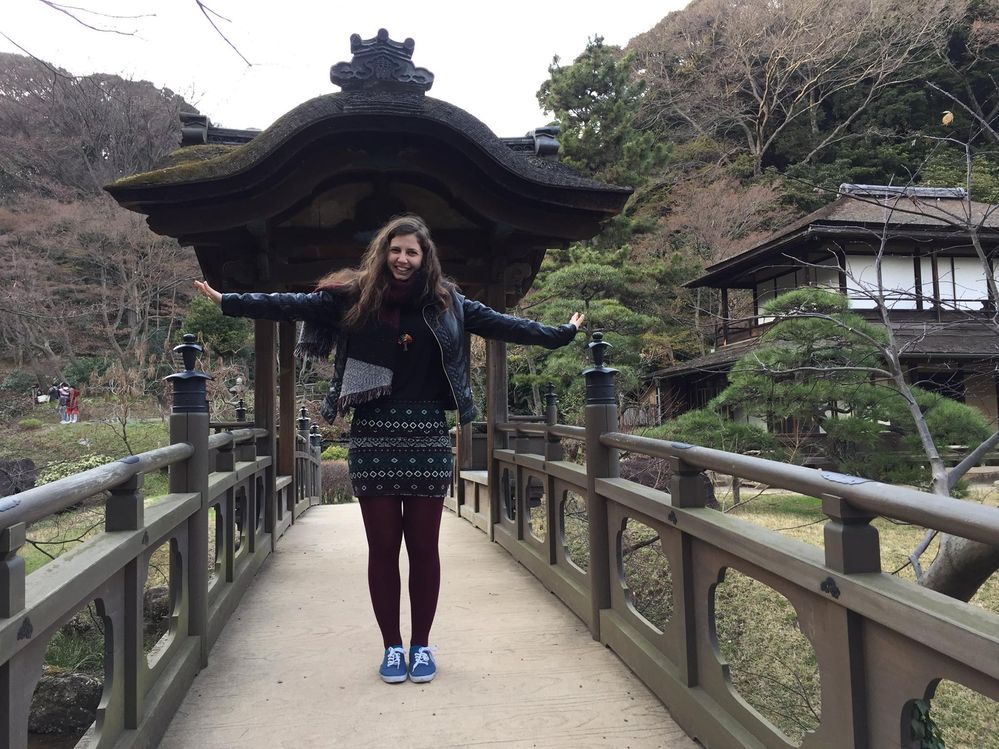 Caption: A photo of Google Moderator @DeniGu, standing with her arms outstretched on a bridge at the Sankeien Garden in Yokohama, Japan. (Local Guide @DeniGu)