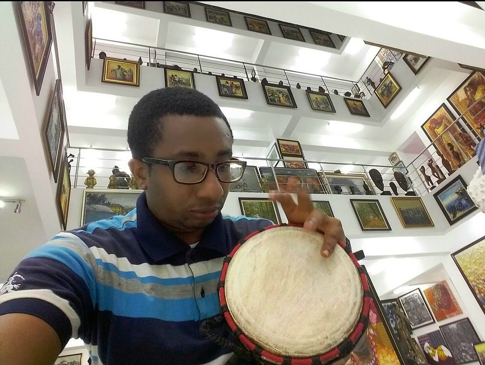 Caption: Local Guide EmekaHouse playing  drum inside the multistorey Nike Art Gallery in Lagos
