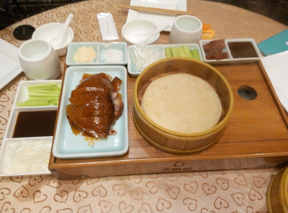 Caption: A photo of Peking duck served on a wooden tray. (Local Guide @TsekoV)