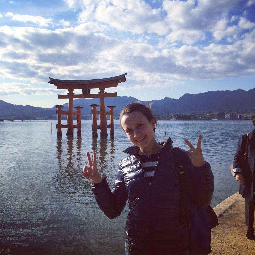 Caption: A photo of Google Moderator Ivi_Ge in front of the Miyajima Torii. (Local Guide @Ivi_Ge)