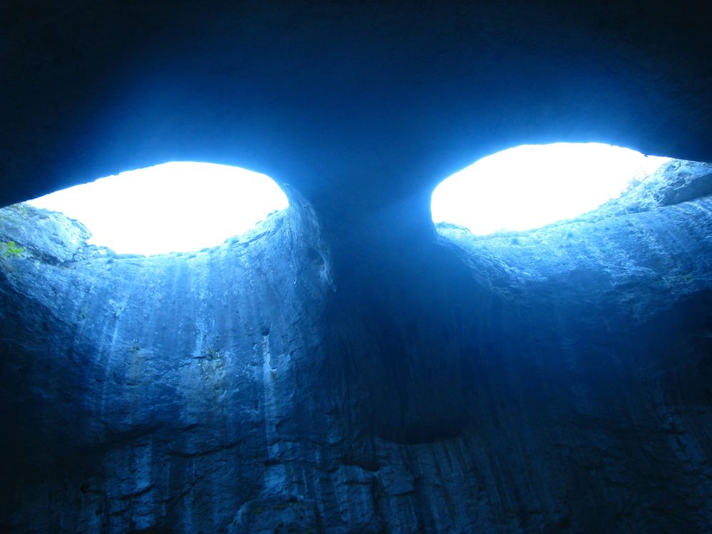 Caption: A photo in Prohodna cave, Bulgaria showing the shape of eyes created by the top cliffs, called the "Eyes of God" (Local Guide @KatyaL)