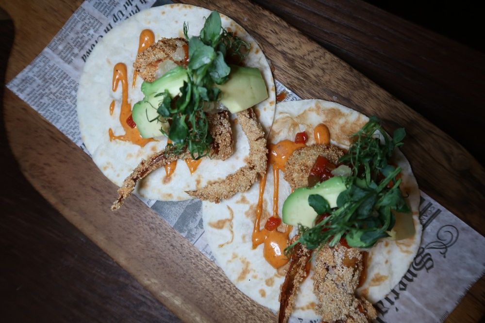 Caption: A photo of two tacos on a wooden board from Toro Toro, a Latin American restaurant in Abu Dhabi. (Local Guide Courtney Brandt)