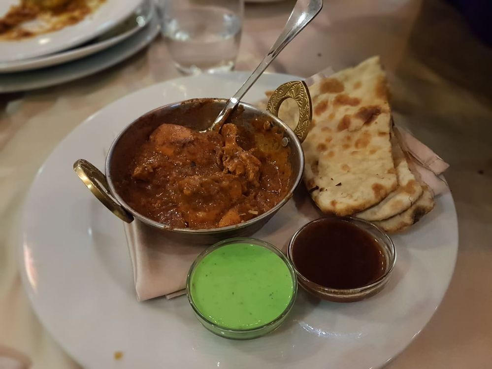 Caption: A photo of Chicken Tikka Masala dish with butter Naan (Local Guide @InaS)