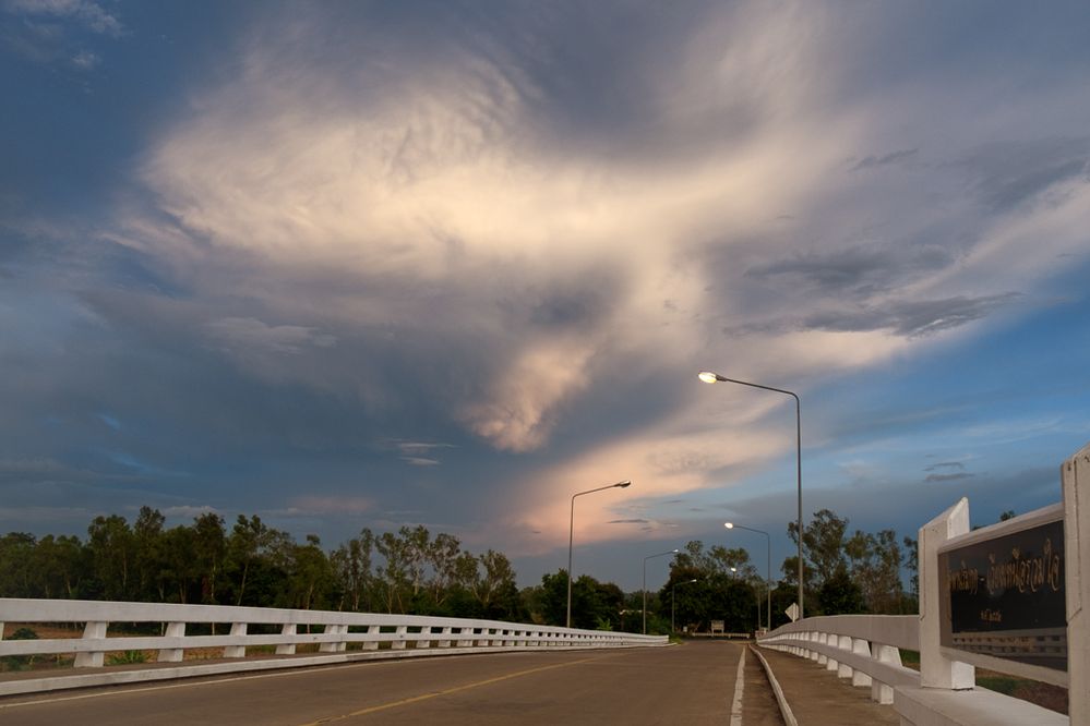 Lively looking clouds throw a few shapes above the bridge at Ban Wiang, Chiang Rai