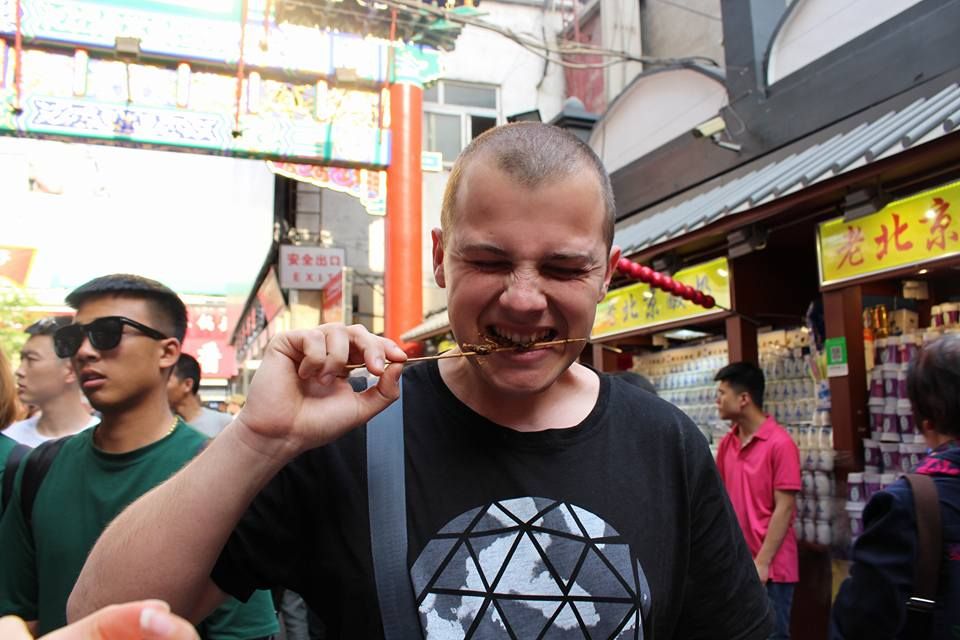 Caption: A photo of me trying fried scorpions on a stick for the first time in Beijing, China. (Local Guide @TsekoV)