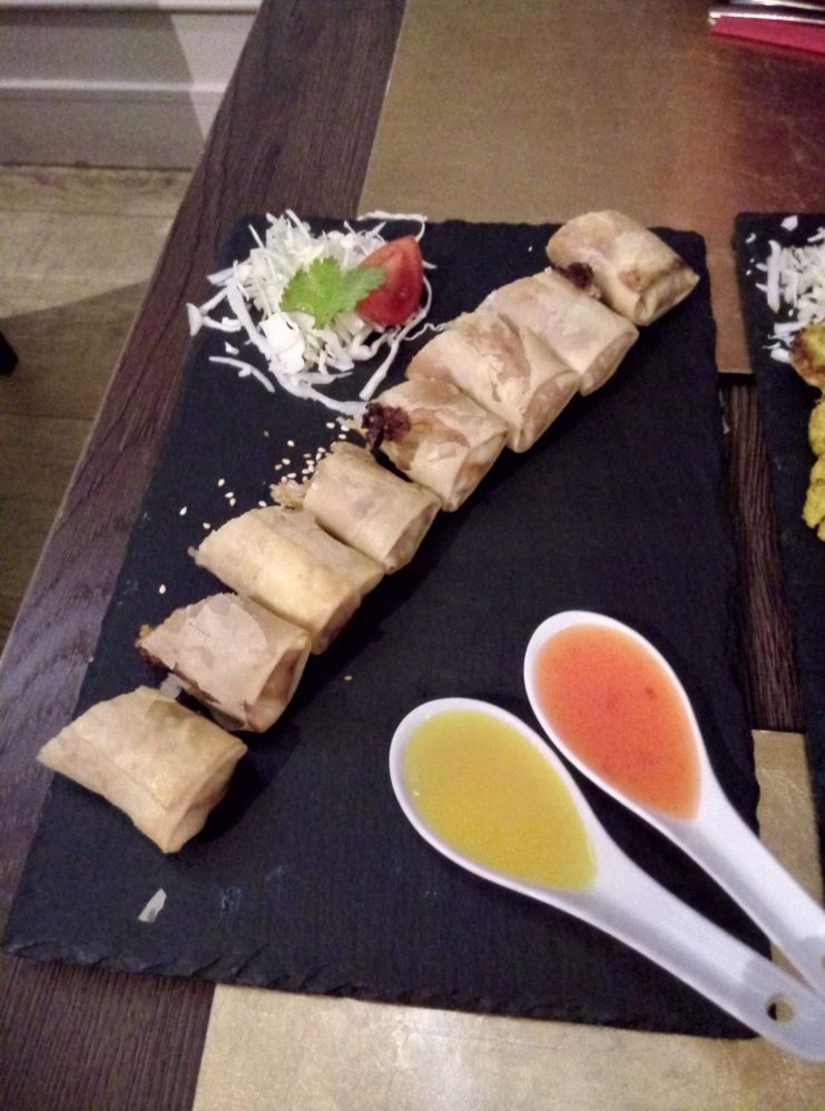 Caption: Homemade vegetarians spring rolls with peanut sauce and sweet and sour sauce on the side. (photo by Klaudiyag)