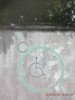 Caption: Photo of a wheelchair sign on the SCIAN fence.