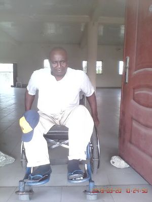 Caption: Photo of man on wheelchair in front of event hall entrance