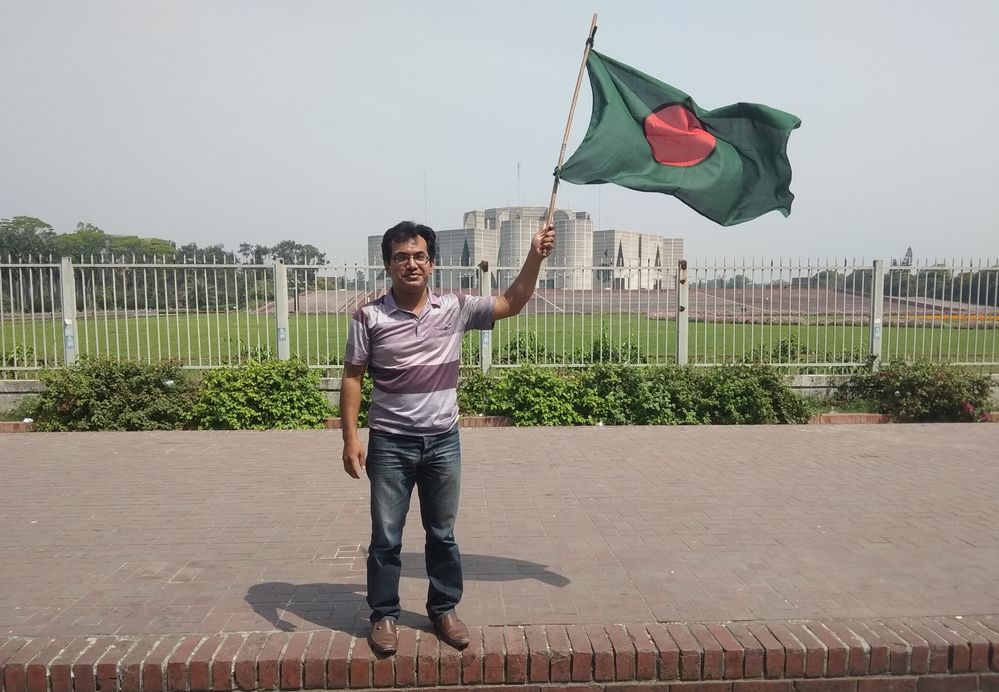 Me holding our national flag at infront of our National Parliament House
