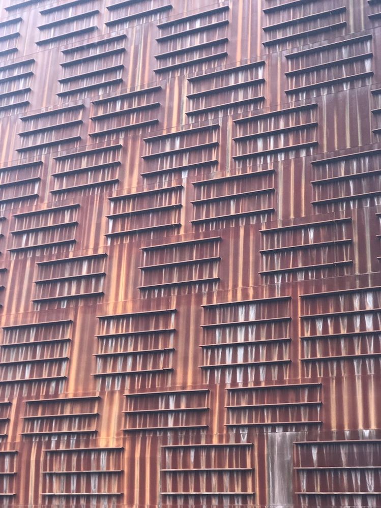 A monochromatic wall. It is all one color but tit has weathered differently plus the way the light hits the building makes it look like two or more different colors.