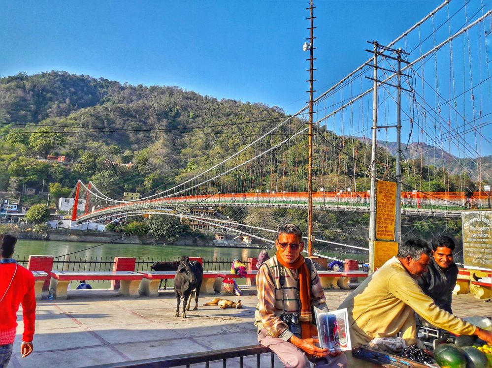 Caption: A photographer is sitting near Ram Jhula, Rishikesh, Uttarakhand, India(Photo by Local Guide Ishant Gautam).