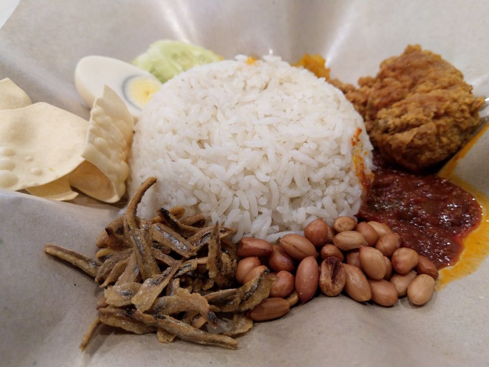 Nasi lemak is a Malay fragrant rice dish cooked in coconut milk and pandan leaf. It is commonly found in Malaysia, where it is considered the national dish of Malaysia. I captured this photo during my Langkawi tour.