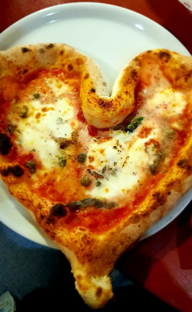 Caption: Close-up of a heart shaped pizza napoletana in Italy (Local Guides @Petra_M)