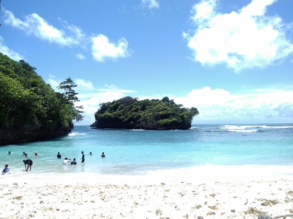 The white sand and blue sea invite you to have the fun you need, Teluk Asmoro Beach, Malang, Indonesia.