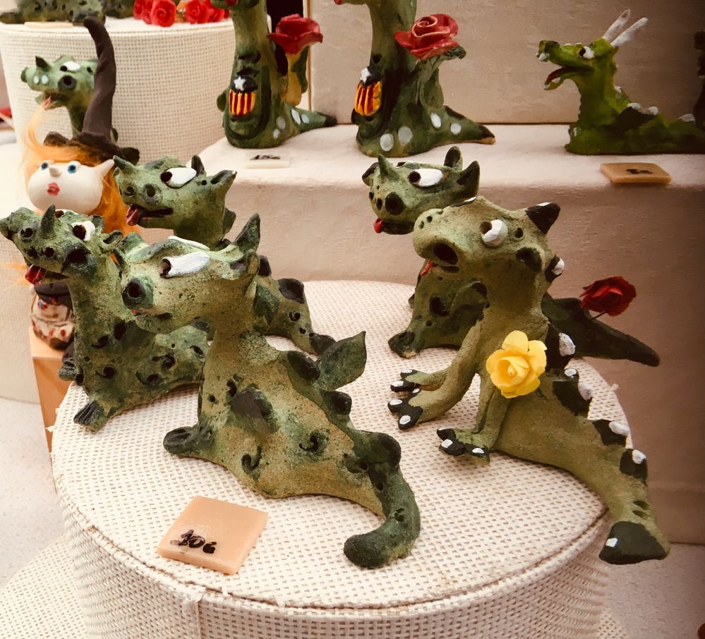 Caption: A street stall displaying a collection of dragons made of clay.