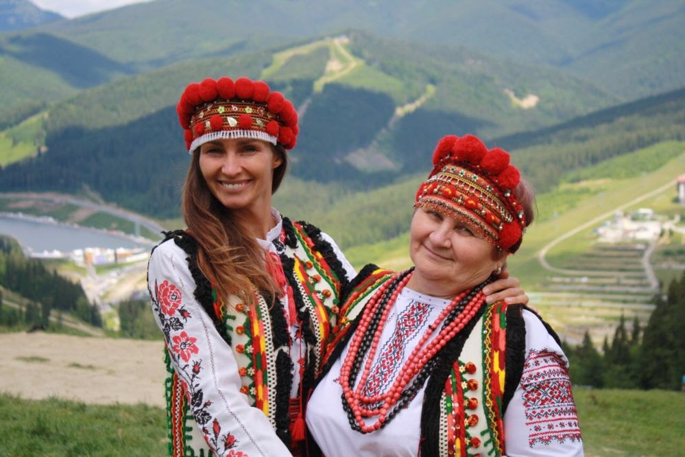 Caption: LG uavalentine & her mom, dressed in embroided vyshyvankas, jackets, and Carpathian hats in Bukovel, Ukraine (LG uavalentine)