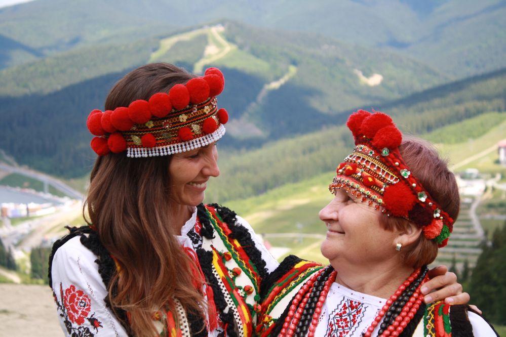 Caption: LG UaValentine and her mom in traditional Ukrainian clothing and the Carpathian mountains in Bukovel Ski Resort behind us, Ukraine (LG uavalentine)