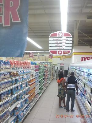 Caption: Photo of another section of the mall fully stocked with affordable goods. Customers are seen checking out the products.