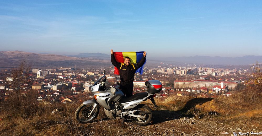 Greetings! This is Me and my motorcycle above the town of Hunedoara, Hunedoara county, Romania