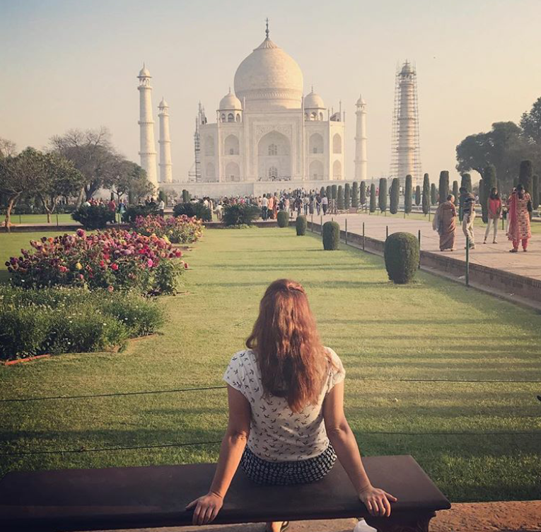 One tourist girl enjoying the taj mahal view afternoon time