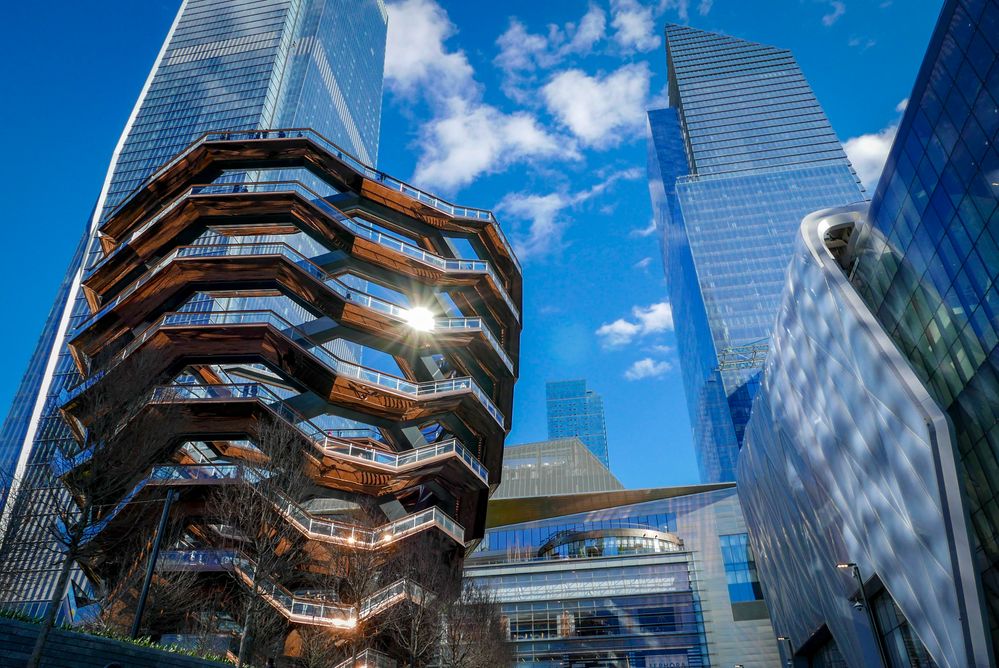 Caption: A photo of the Vessel staircase tourist attraction, reflecting the sun off its glass and metal structure in Hudson Yards, New York, USA. (Local Guide Rita Meirina)