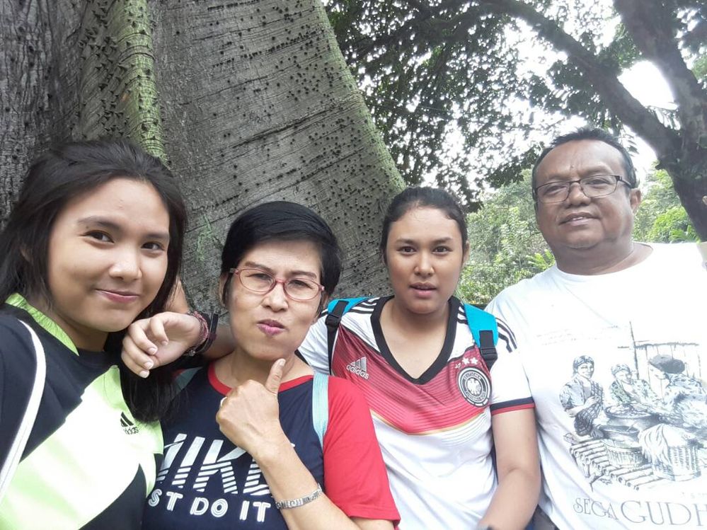 The whole family in front of a big tree at Pajajaran sidewalks.
