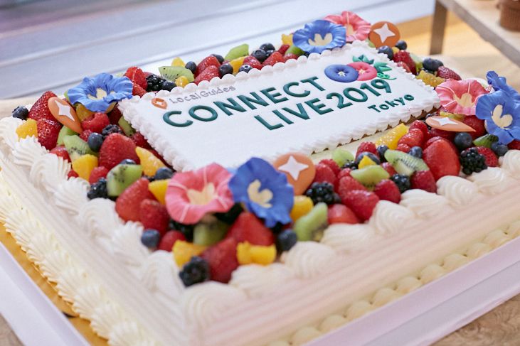 Caption: A photo of a colorful cake topped with fresh fruit and the words “Connect Live Tokyo 2019”.