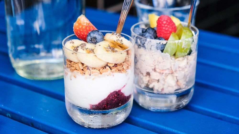 Caption: A photo of glasses filled with yogurt, granola, and fruit with spoons in them on a table. (Local Guide Jennifer Fu)
