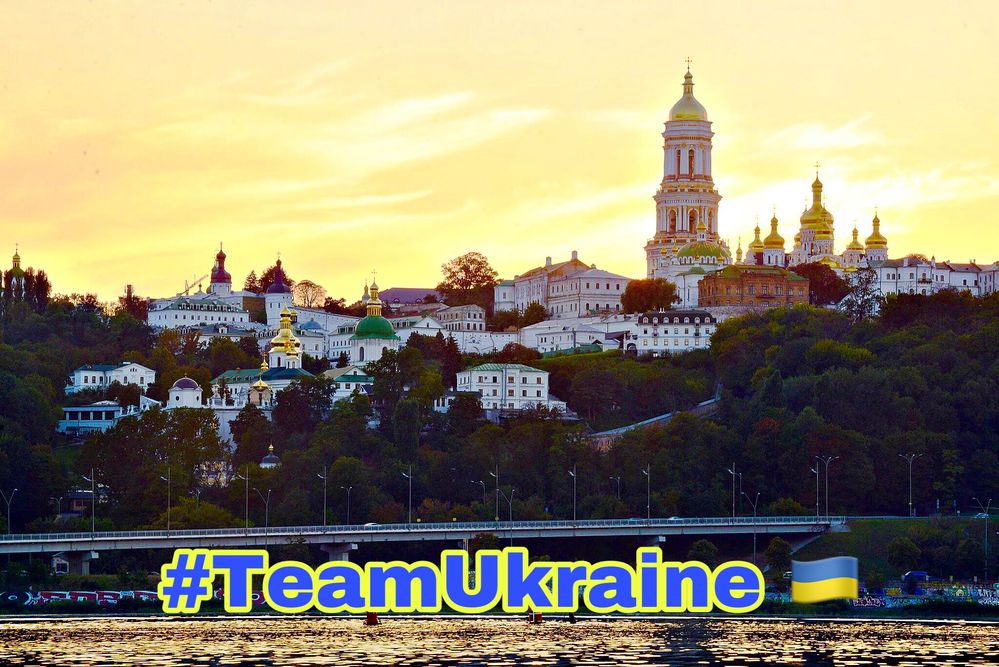 Caption: Kyiv Pechersk Lavra on the hills of the Dnipro river in the lights of the sunset with #TeamUkraine tag (photo credit @GLG_BVF)