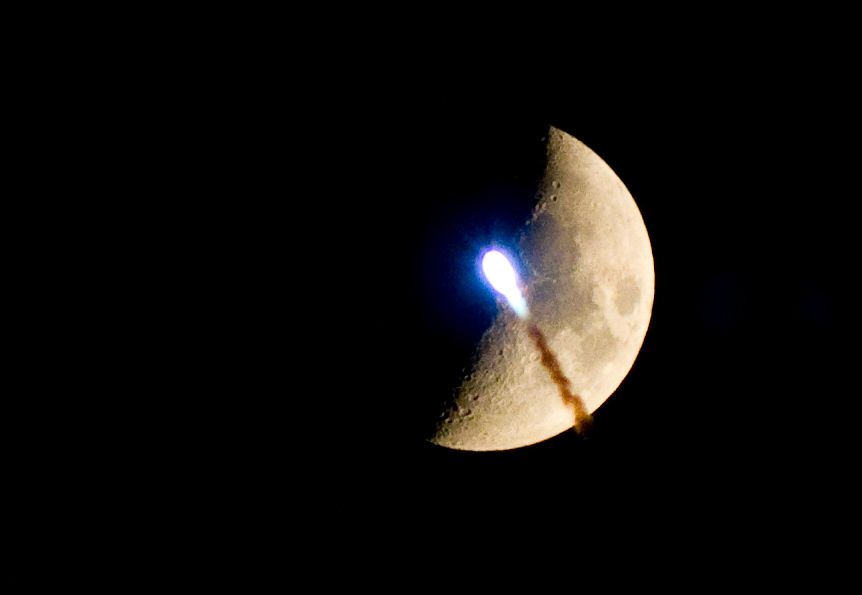 Scorrano, Puglia, a firework passes against the moon