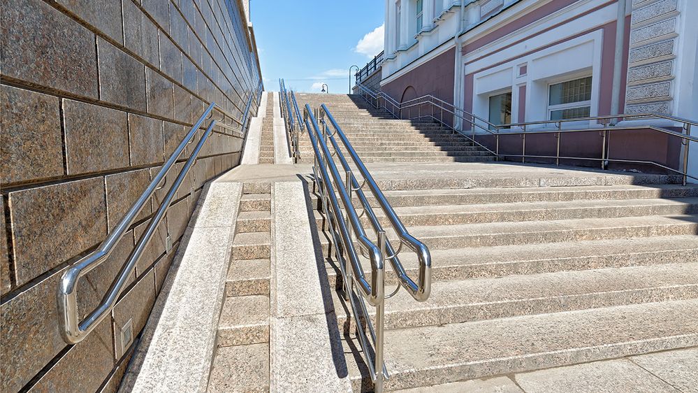 Caption: A photo of an accessible ramp and stairway next to a building. (Getty Images)