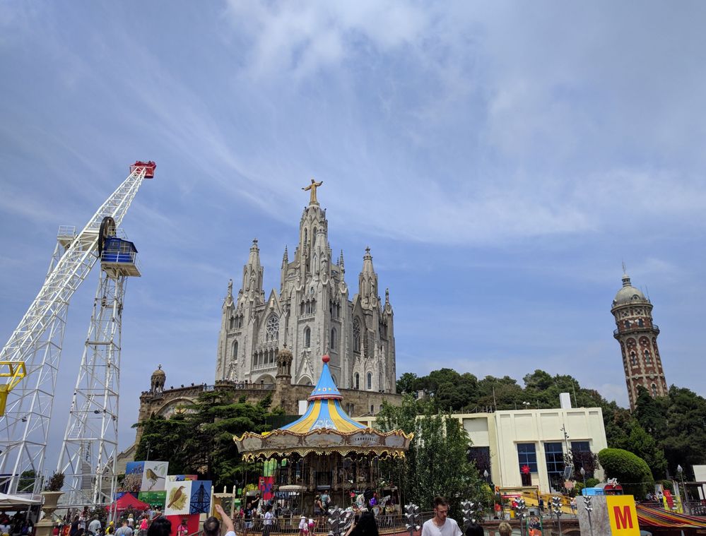 Caption: A photo of the amusement park and Catholic church at the top of Mount Tibidabo, Barcelona. (Local Guide @MoniDi)
